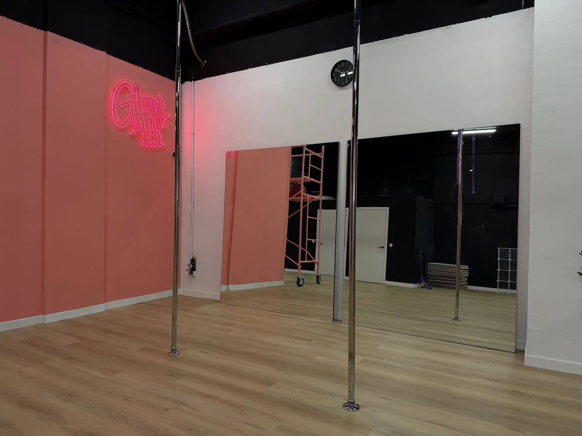 Open Pole room with the Glow Up neon sign