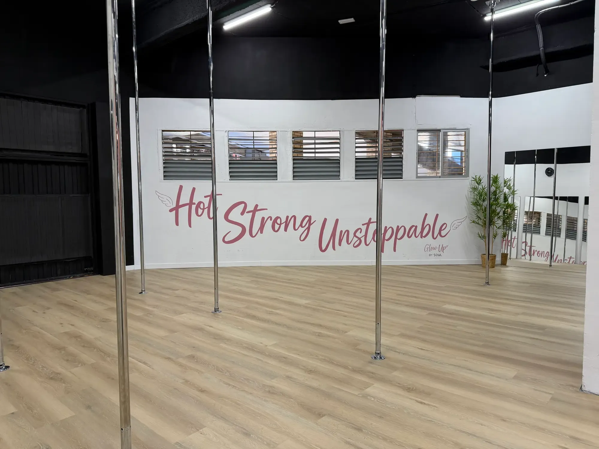 Pole room with the words Hot Strong Unstoppable on the wall